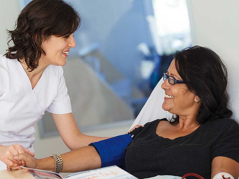 Nurse attending patient in bed